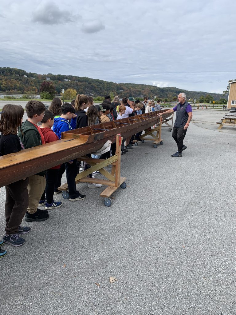 Before boarding the bus back to school, Vassar Crew Coach Peter Wells showed them a wooden shell, probably from the 1950's that's been in their boathouse for a while.